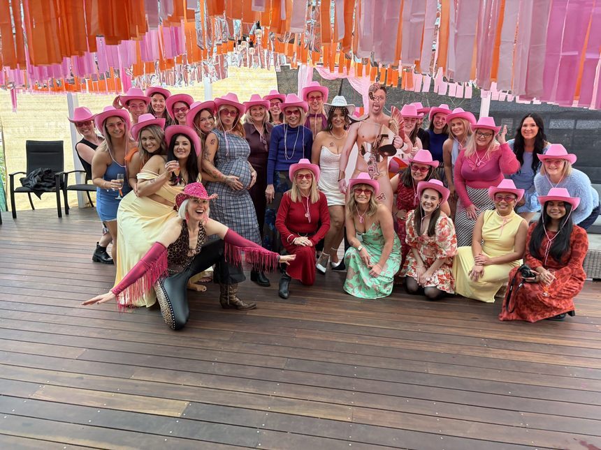 A Boot Scooting Society hen's party — the whole crew in pink cowboy hats