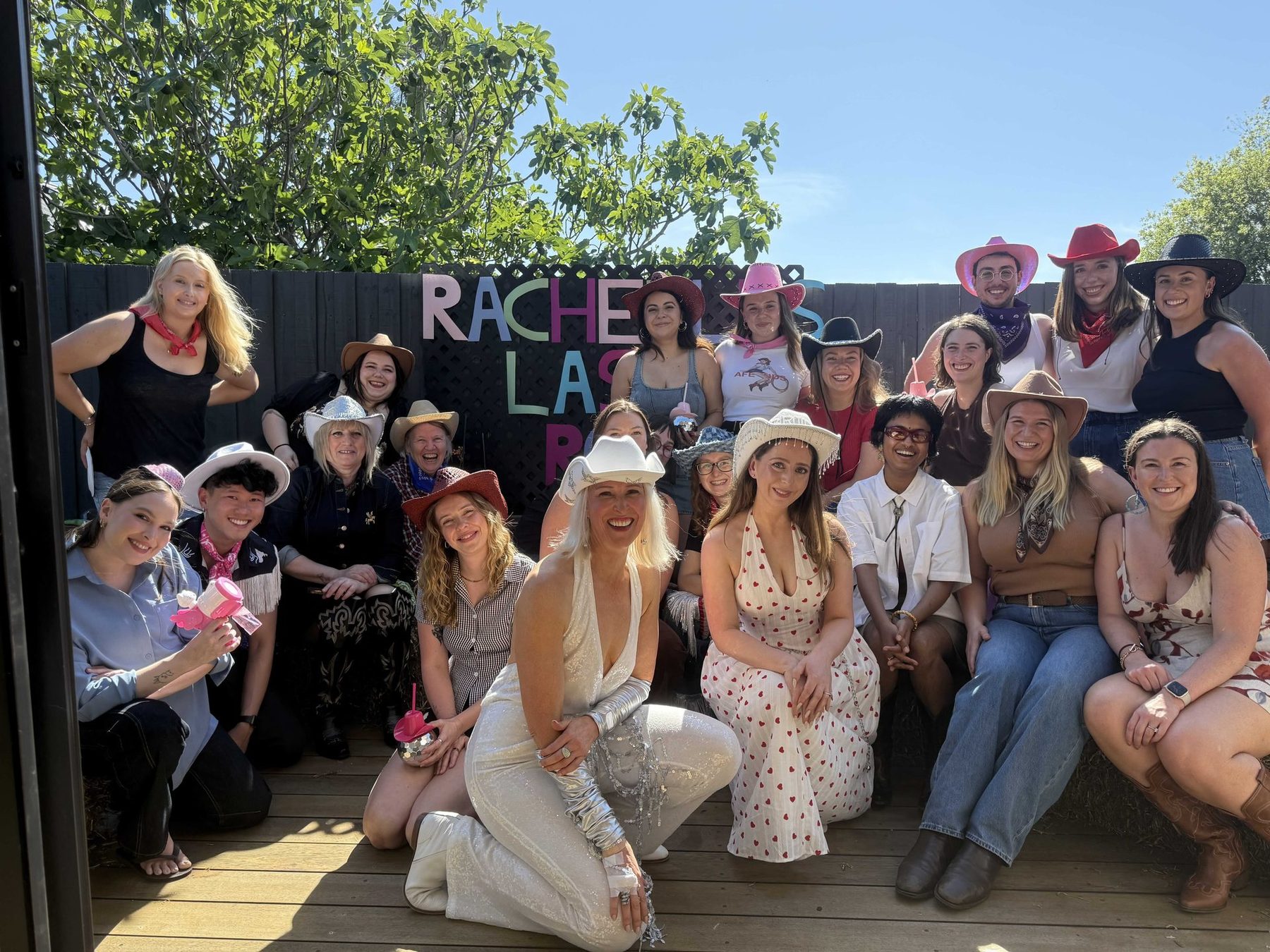 A Boot Scooting Society hen's party group in white outfits and cowboy hats