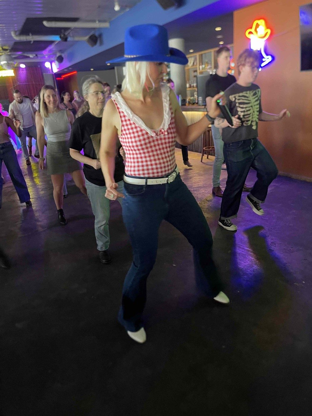Kirsten Mann line dancing at a Boot Scooting Society event