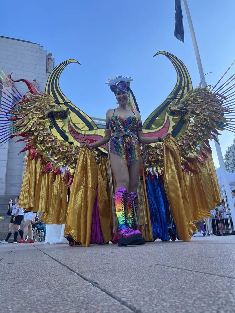 Gold-winged Mardi Gras costume with rainbow boots
