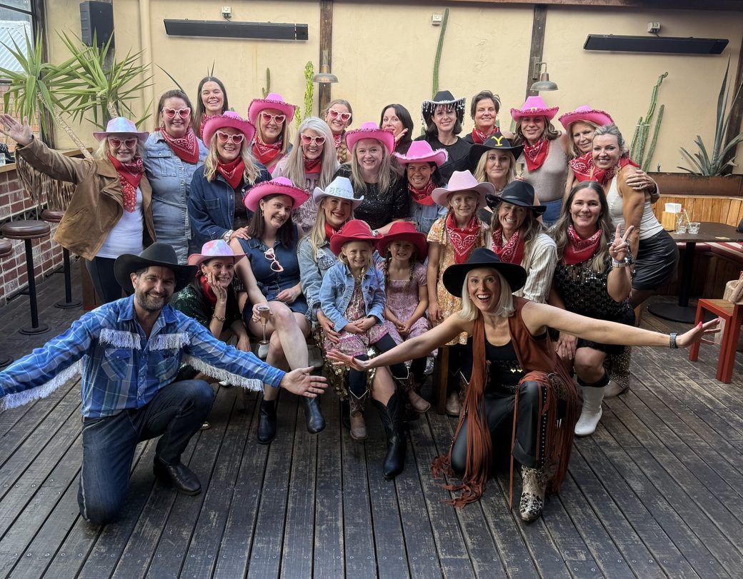 Hen's party line dancing in cowboy hats
