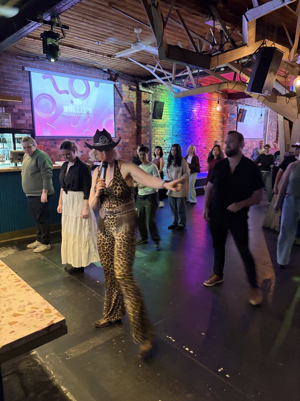 A huge crowd up line dancing with Boot Scooting Society at a public event